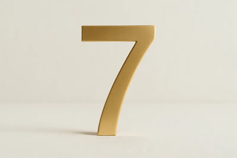 Single large golden seven symbol on cream background with soft shadow